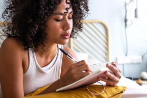 MidwestModelSupply-361348-Young-Woman-Journaling-Image1